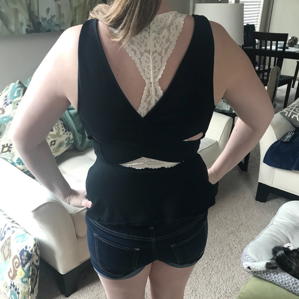 Black peplum tank with cutout details